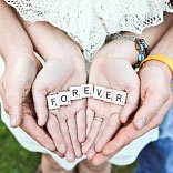 Two Pairs of Hands Holding Scrabble Letters Two Pairs of Hands Holding Scrabble Letters